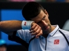Novac Djokovic wipes sweat from his forehead.